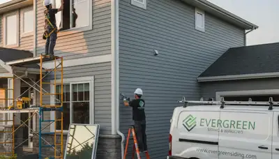 Technician repairing vinyl siding and windows on home exterior in Cincinnati, OH